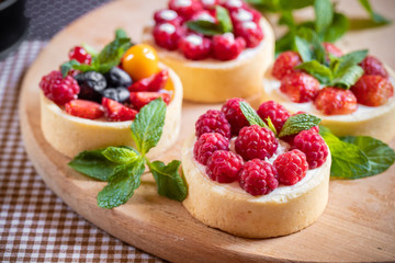 raspberry cake with cream cheese, mint on crumbly dough. Cake with raspberries