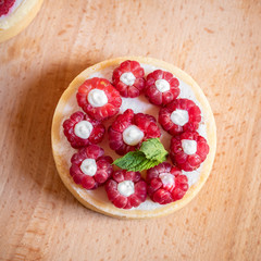 raspberry cake with cream cheese, mint on crumbly dough. Cake with raspberries