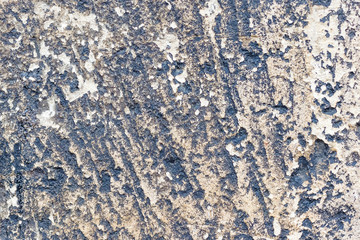 The texture of the old gray stone on the wall of the medieval temple_