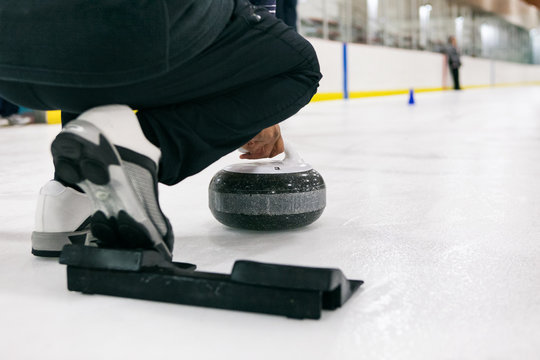 Curling: Thrower About To Release Stone Down Sheet