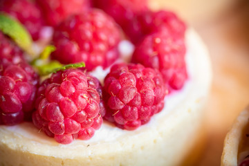 raspberry cake with cream cheese, mint on crumbly dough. Cake with raspberries