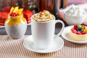 cup of coffee with whipped cream and dipping