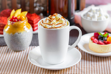 cup of coffee with whipped cream and dipping