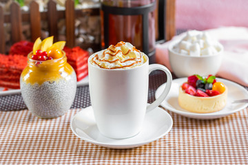 cup of coffee with whipped cream and dipping
