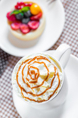 cup of coffee with whipped cream and dipping