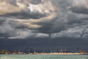 Fototapeta premium Very dark clouds over commercial dock