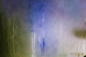 Texture flowing drops on the glass - blurred background