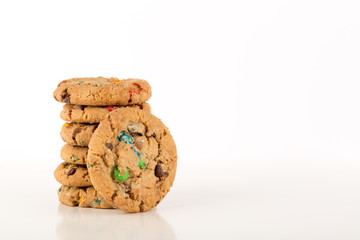 chocolate chip cookies on white background, reflective surface, stacked cookies, Copy space