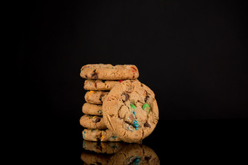 chocolate chip cookies on gradient black background, reflective surface, stacked cookies, Copy space