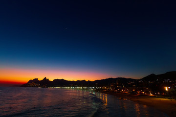 Dusk over the beaches of Ipanema and Leblon in Rio de Janeiro (Brazil) with Two Brothers hill in the background
