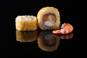 delicious sushi roll with shrimp on a black background with reflection