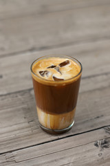 Iced coffee latte isolated on wooden table