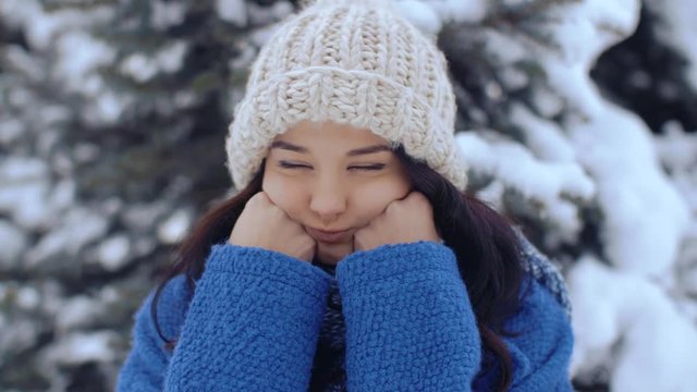 Spoiled winter holidays concept. Bored sad woman let's out a deep breath outdoors in winter.Clouse-up portrait od lonely dissatisfied attractive young girl wasting her time during vication on nature