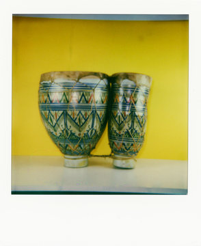 Polaroid scan of bongo drums on a yellow background