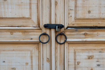 Wooden door with round iron knobs and lock