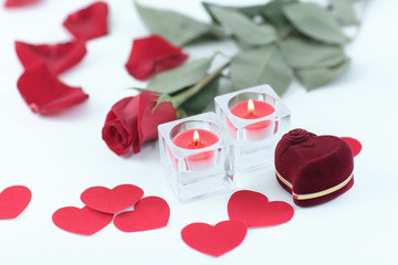 romantic concept . ring, candles and rose on white background