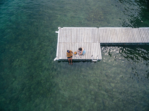 Woman cutting stone fruit on the dock