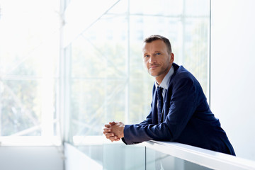 Portrait Of Businessman Leaning On Railing