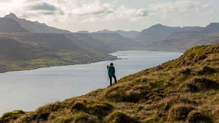 Fototapeta na wymiar Girl exploring the beautiful highlands in Faroe Islands
