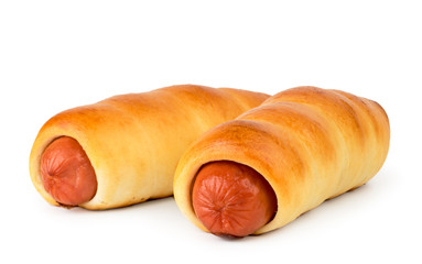 Two sausages in the dough close-up. Isolated.