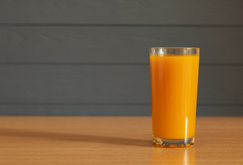 Glass of fresh  juice on wooden table with copy space background
