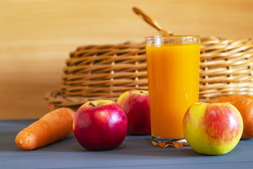 Glass of fresh  juice with fresh fruits and vegitables on wooden table, healthy food