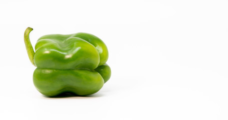 Green bell pepper isolated on white background.