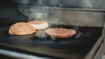 Close up. Worker Cooking Burger in Food Truck.