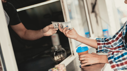 Young Woman in Shirt Buying Coffee in Food Truck.