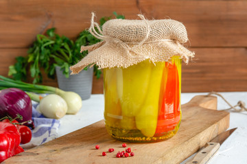 Jar of pickled cucumbers and red pepper. Marinated and canned vegetables food.