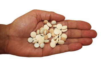 Handful of pills in palm on white background, close-up. Assorted medication in hand. Advertising healthy lifestyle, but also possibility of addiction to medication and overdose. Horizontal.