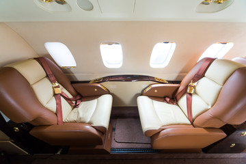 Luxury interior in bright and brown colors in the private business jet