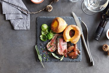 
    Roast beef with yorkshire pudding, brussels sprouts and shallots. Traditional british roast...