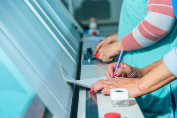 Worker at a weaving factory. Fabric production. Textile industry. Production of specialized tissue machine. Check the quality of the fabric.