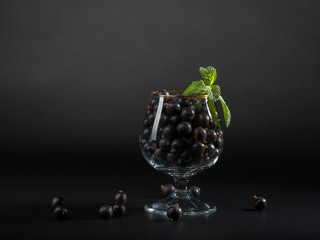 A glass of black currant berries