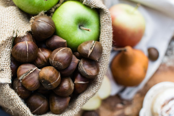 Autumn composition Chestnuts, apples and pear