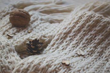 A knitted woolen texture with natural decor. Cold season background.