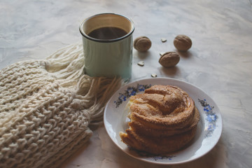A cup of tea and cookie on a table.