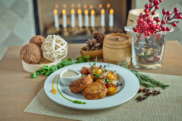 Fototapeta na wymiar fried cutlets with potatoes in a plate on a wooden table