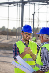 Engineers shaking hands on construction site