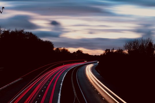 motor way freeway head and tail lights trailing along in red and white