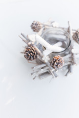 Festive Christmas and New Year handmade decoration candlestick with pine cones and branches