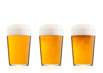 Cold glasses of lager beer with foam and dew