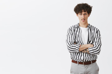 Naughty immature good-looking and stylish male model with cute moustache and curly hairstyle...