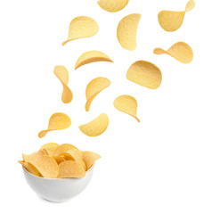 Bowl of tasty crispy potato chips on white background