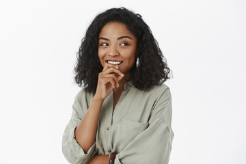 Hmm he seems okay. Portrait of flirty and curious feminine cute dark-skinned female coworker in...
