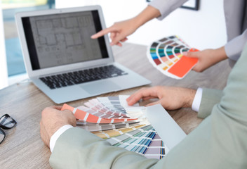 Naklejka na ściany i meble Team of designers working with color palettes at office table, closeup