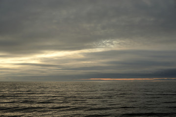 Naklejka na ściany i meble Cloud sunset over sea.