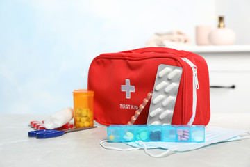 First aid kit with pills on table indoors
