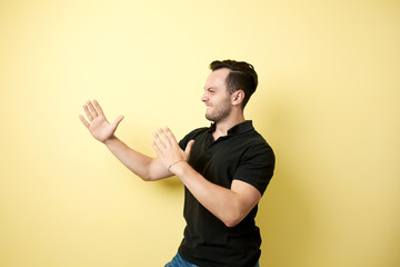 Aggressive guy dressed in the black t-shirt ready to fighting